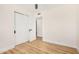 Bright bedroom with light wood floors and modern, white, sliding-door closet at 1368 W 14Th St, Tempe, AZ 85281