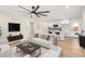 Bright living room with modern fan, white sofa, and open access to a renovated kitchen at 1368 W 14Th St, Tempe, AZ 85281