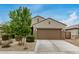 Well-maintained single-story home boasts a two-car garage, desert landscaping, and inviting curb appeal at 17573 W Via De Luna Dr, Surprise, AZ 85387