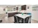 Well-appointed kitchen with ample counter space, sleek dark cabinets, and a view to the adjacent living area at 17573 W Via De Luna Dr, Surprise, AZ 85387