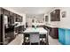 Modern kitchen with dark cabinetry, stainless steel appliances, and a stylish center island with a marble countertop at 17573 W Via De Luna Dr, Surprise, AZ 85387