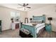Well-lit main bedroom featuring stylish turquoise furniture, neutral walls, and ample natural light at 17573 W Via De Luna Dr, Surprise, AZ 85387