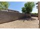 Backyard featuring block wall, xeriscaping, and mature trees providing shade at 18391 W Stinson Dr, Surprise, AZ 85374
