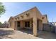 Exterior rear view of covered patio, xeriscaped yard, and stucco exterior at 18391 W Stinson Dr, Surprise, AZ 85374