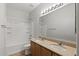 Bathroom with granite countertop, dual sinks, a tub, and a convenient toilet at 18391 W Stinson Dr, Surprise, AZ 85374