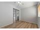 This bedroom has wood-look floors, light walls, and a ceiling fan at 18391 W Stinson Dr, Surprise, AZ 85374