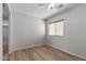 The bedroom features light gray walls, wood-look floors, and a ceiling fan at 18391 W Stinson Dr, Surprise, AZ 85374