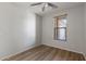 Well-lit bedroom with a ceiling fan and wood-look flooring, complemented by a window at 18391 W Stinson Dr, Surprise, AZ 85374