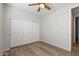 Bedroom with a ceiling fan, closet, and wood-look flooring for easy maintenance at 18391 W Stinson Dr, Surprise, AZ 85374