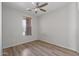 A clean, bright bedroom offers a ceiling fan and light wood-look flooring at 18391 W Stinson Dr, Surprise, AZ 85374