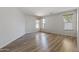 Large, bright bedroom with wood-look floors and three windows with wood blinds at 18391 W Stinson Dr, Surprise, AZ 85374