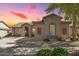 Inviting single-story home featuring desert landscaping and a tile roof at sunset at 18391 W Stinson Dr, Surprise, AZ 85374