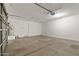 Spacious garage with door, water heater, and concrete floor at 18391 W Stinson Dr, Surprise, AZ 85374