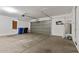View of a three car garage with door to house, and water heater at 18391 W Stinson Dr, Surprise, AZ 85374