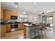 Bright eat-in kitchen features stainless appliances and light wood cabinets at 18391 W Stinson Dr, Surprise, AZ 85374