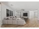 Spacious living room is furnished with a sectional couch and a mounted TV at 18391 W Stinson Dr, Surprise, AZ 85374