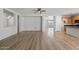 Bright living room with wood floors and an open floor plan adjacent to the updated kitchen at 18391 W Stinson Dr, Surprise, AZ 85374