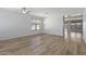 Spacious living room with wood-look flooring, neutral walls, and view of the home's floorplan at 18391 W Stinson Dr, Surprise, AZ 85374