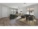 Cozy living room features a ceiling fan, wood floors, and dual windows at 18391 W Stinson Dr, Surprise, AZ 85374