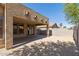 View of covered patio overlooking the backyard with gravel and privacy wall at 18391 W Stinson Dr, Surprise, AZ 85374