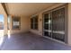 View of covered patio with sliding door and backyard access at 18391 W Stinson Dr, Surprise, AZ 85374