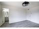 Open bedroom with modern light, wood-look floors, and access to a bathroom enhances convenience and comfort at 2018 W Western Dr, Chandler, AZ 85224