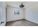 Bright bedroom features wood-look floors, a modern ceiling fan, and a window overlooking the yard at 2018 W Western Dr, Chandler, AZ 85224