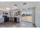 Remodeled kitchen features gray cabinets, stainless appliances, quartz countertops and a view to the backyard at 2018 W Western Dr, Chandler, AZ 85224