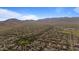 Expansive aerial view of a desert community nestled against stunning mountain backdrop under a vast blue sky at 20638 W Main St, Buckeye, AZ 85396