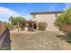 Spacious backyard with a patio, outdoor kitchen, dining area, and green space at 20638 W Main St, Buckeye, AZ 85396