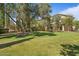 A spacious backyard with lush green grass and shade trees create a peaceful outdoor retreat at 20638 W Main St, Buckeye, AZ 85396