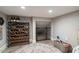 Finished basement area with a wine rack, gated storage, and neutral decor perfect for additional living space at 20638 W Main St, Buckeye, AZ 85396
