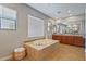 Large bathroom with soaking tub and plenty of natural light at 20638 W Main St, Buckeye, AZ 85396