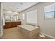 Large bathroom with soaking tub, tile floors, and double vanity at 20638 W Main St, Buckeye, AZ 85396