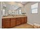 Vanity with wood cabinets, tile backsplash and tile floors at 20638 W Main St, Buckeye, AZ 85396