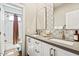 Modern bathroom featuring dual vanities with sleek fixtures and subway tile shower at 20638 W Main St, Buckeye, AZ 85396