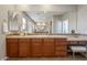 Vanity with wood cabinets, tile backsplash and tile floors at 20638 W Main St, Buckeye, AZ 85396