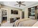 Bright bedroom with a walk-in closet, TV, and an ensuite bathroom at 20638 W Main St, Buckeye, AZ 85396