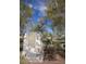 A stone sign welcomes visitors to Mesquite Grove, a community nestled amongst trees and blue skies at 20638 W Main St, Buckeye, AZ 85396