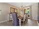 Elegant dining room with chandelier lighting, stylish furniture, and French doors to the outdoors at 20638 W Main St, Buckeye, AZ 85396
