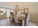Bright dining area featuring a beautiful chandelier, a buffet, and modern decor elements at 20638 W Main St, Buckeye, AZ 85396