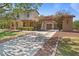 Charming home showcasing a well-manicured lawn, mature trees, and a welcoming entrance with a two-car garage at 20638 W Main St, Buckeye, AZ 85396