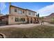 Beautiful home with a spacious backyard with an outdoor dining area, built-in grill, and stone accents at 20638 W Main St, Buckeye, AZ 85396