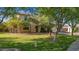 Charming two-story home with well-manicured lawn and mature trees at 20638 W Main St, Buckeye, AZ 85396