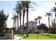 Founders Park showcases a charming archway surrounded by palm trees, green grass and desert landscaping at 20638 W Main St, Buckeye, AZ 85396