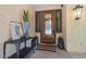Elegant front entrance featuring a wood door, stylish lanterns, and decorative interior accents at 20638 W Main St, Buckeye, AZ 85396