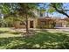 Charming home featuring lush front yard with mature landscaping and a traditional exterior at 20638 W Main St, Buckeye, AZ 85396