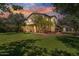 Beautiful home with a large front yard, mature trees, and lush green grass creating an inviting curb appeal at 20638 W Main St, Buckeye, AZ 85396