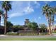 Elegant Verrado Golf Club building with red tile roof surrounded by lush palms under a sunny sky at 20638 W Main St, Buckeye, AZ 85396