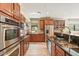 Well-lit kitchen featuring stainless steel appliances and wooden cabinetry providing ample storage at 20638 W Main St, Buckeye, AZ 85396